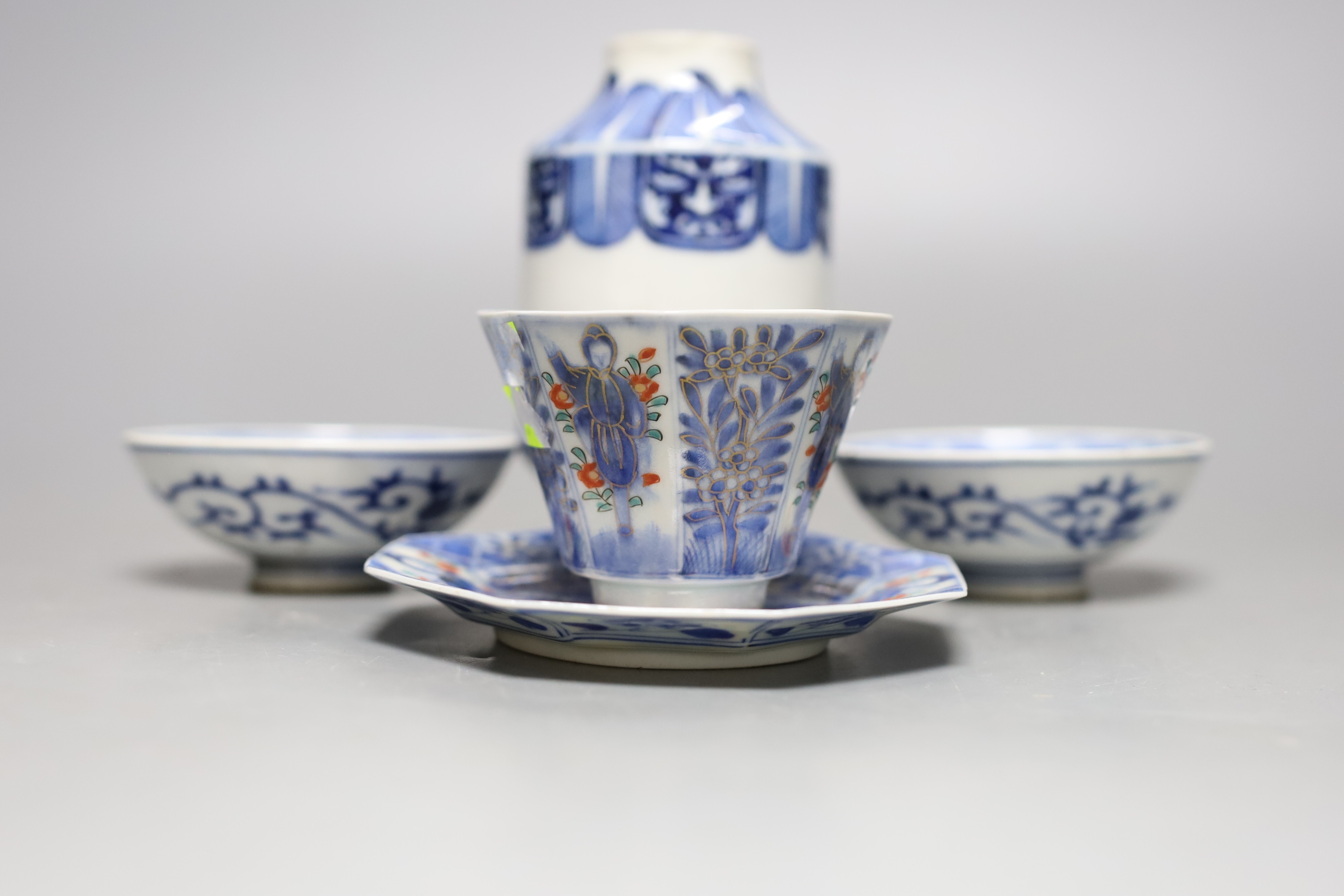 A Japanese blue and white vase, two similar dishes and a tea bowl and saucer